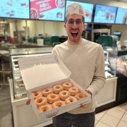 Holding Krispy Kreme doughnuts